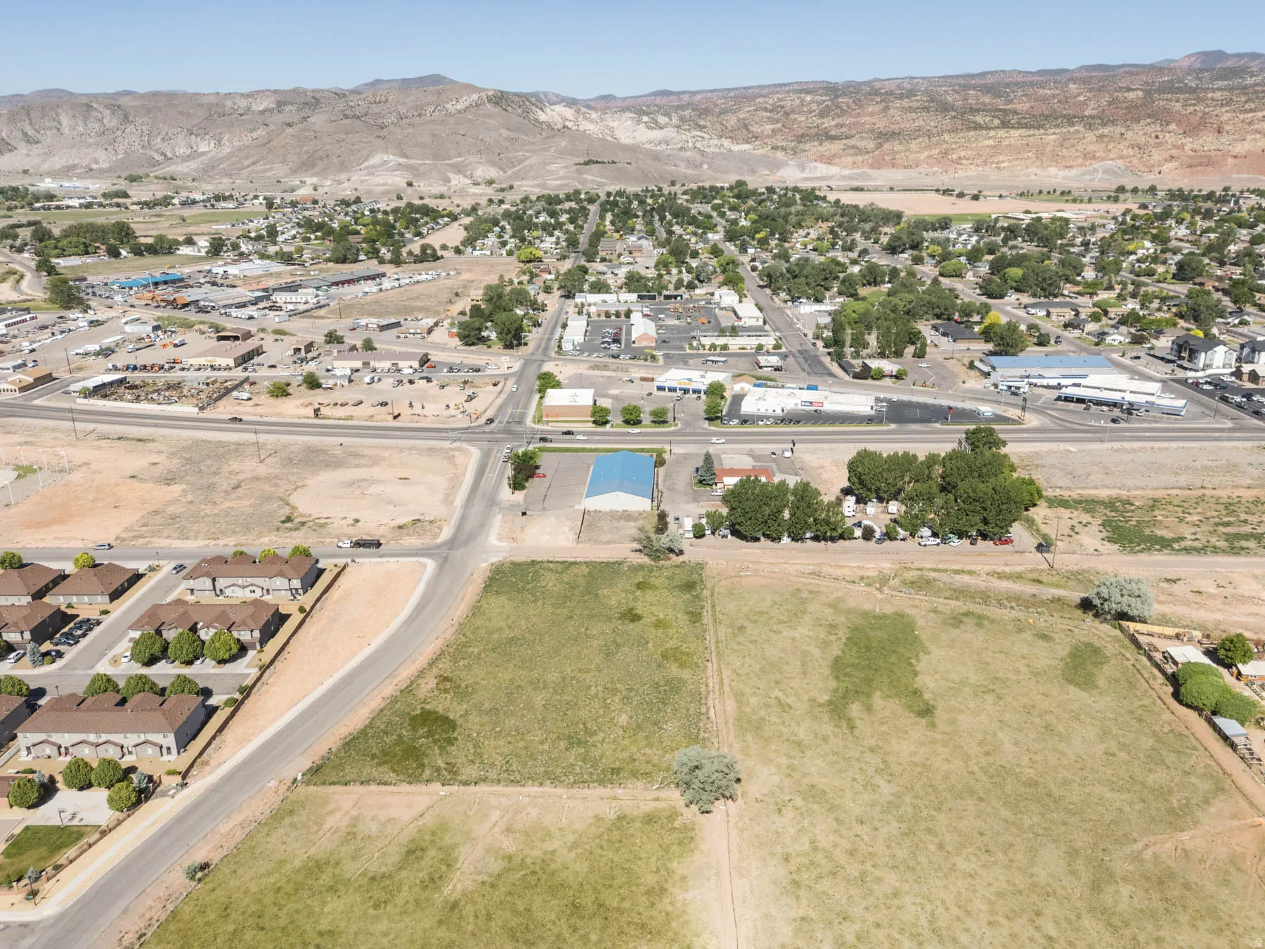 Expansive land parcel featuring open fields and distant mountain scenery