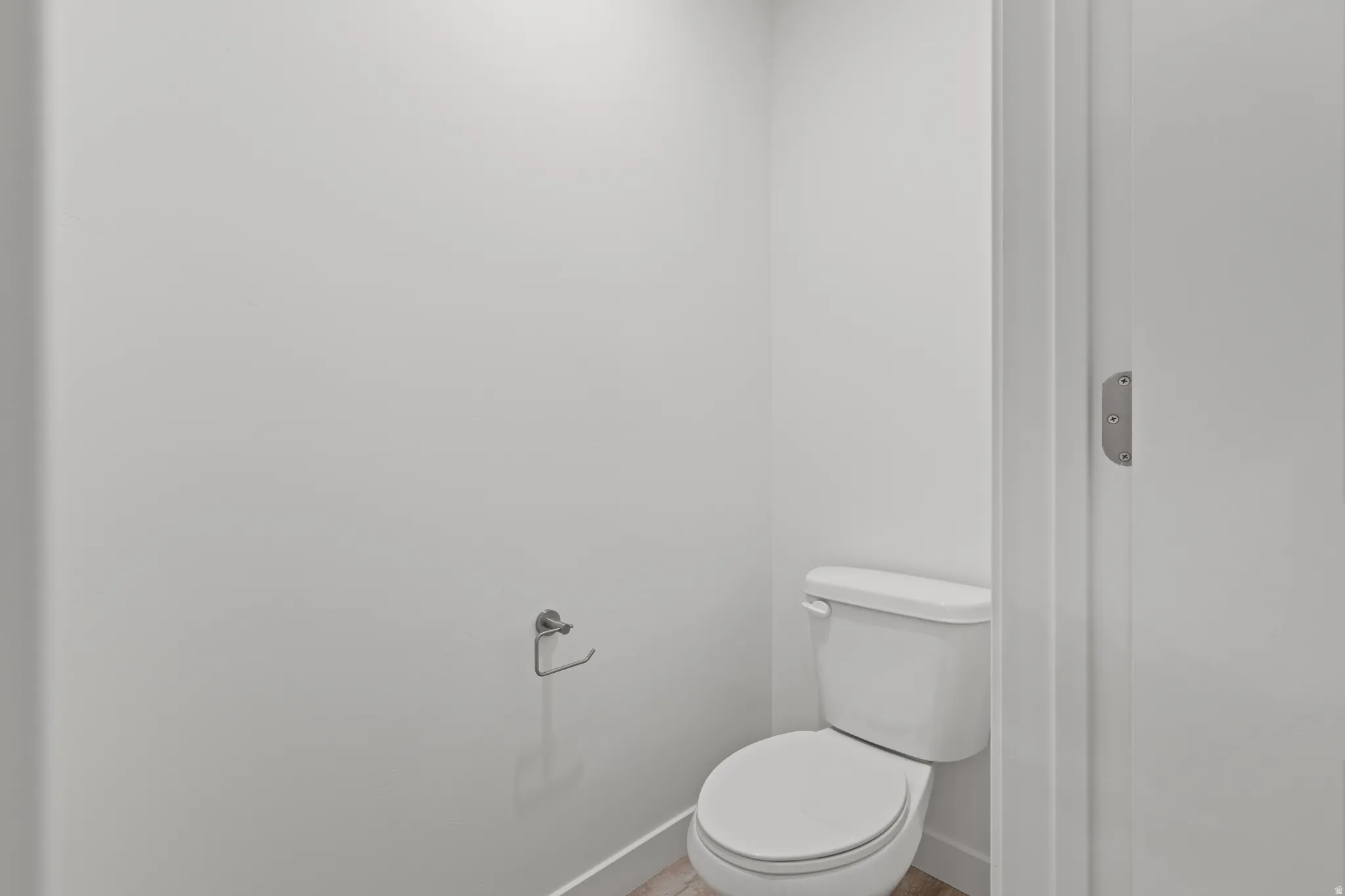 White toilet fixture with a coordinating toilet paper holder