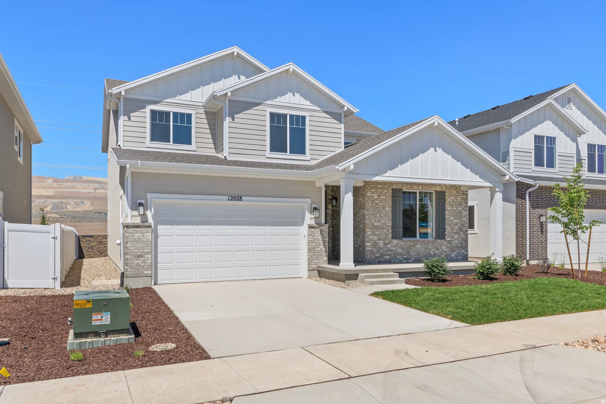 Contemporary two-story residence featuring light gray siding and white trim