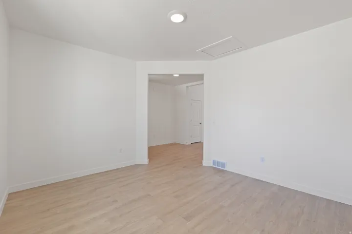 Open concept room featuring light wood-finish flooring, white walls, and recessed lighting