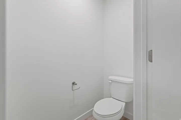 White toilet fixture with a coordinating toilet paper holder