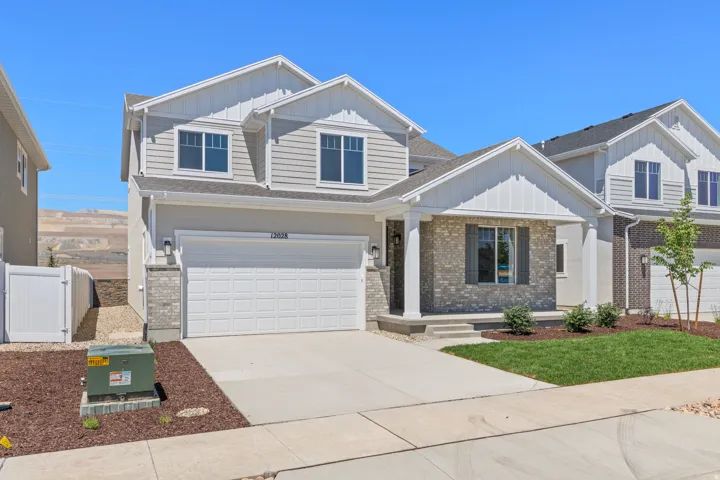 Contemporary two-story residence featuring light gray siding and white trim