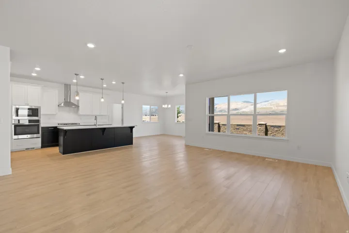 Open-concept living area featuring light wood-finish flooring throughout