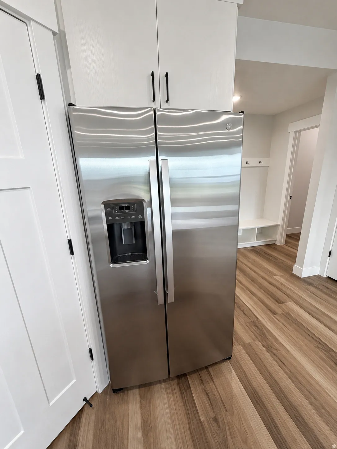 Stainless steel side-by-side refrigerator with an integrated ice and water dispenser