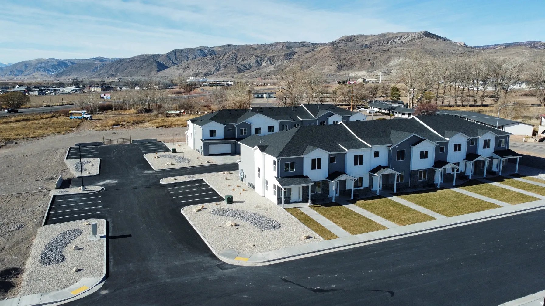 Modern townhomes with two-tone siding and dark shingle roofs