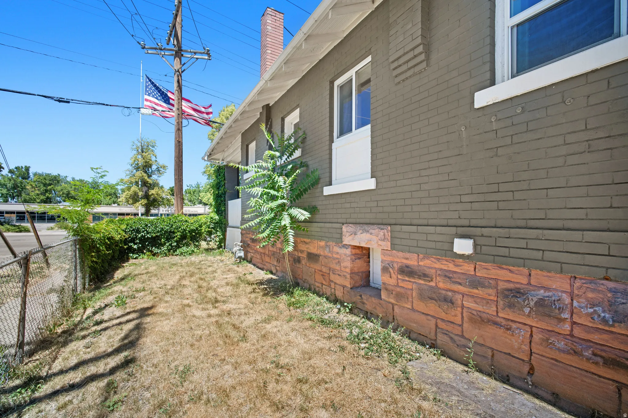 Exterior brick siding in a neutral tone and a decorative stone-look foundation