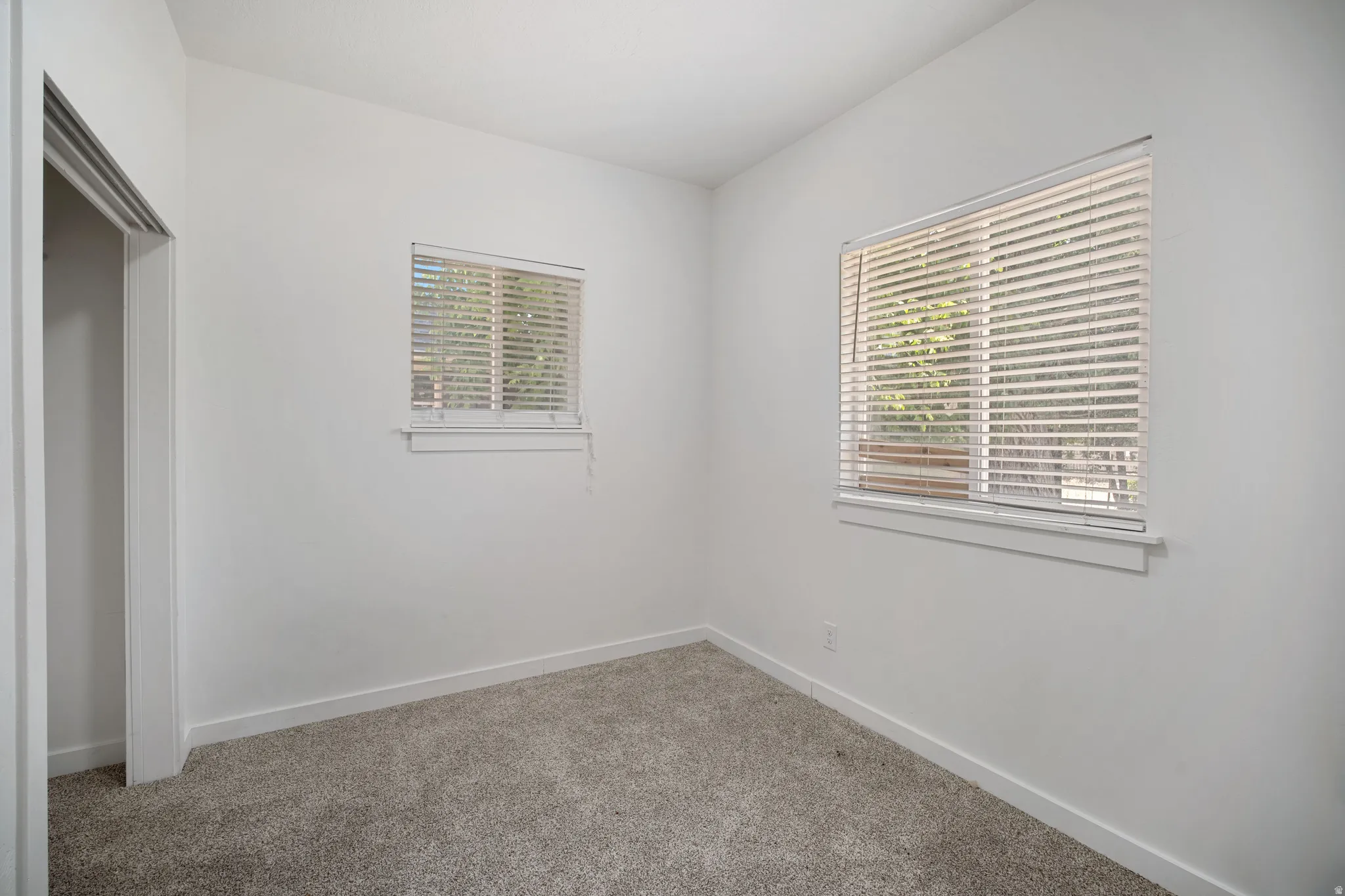 Room featuring neutral carpeting and white wall finishes