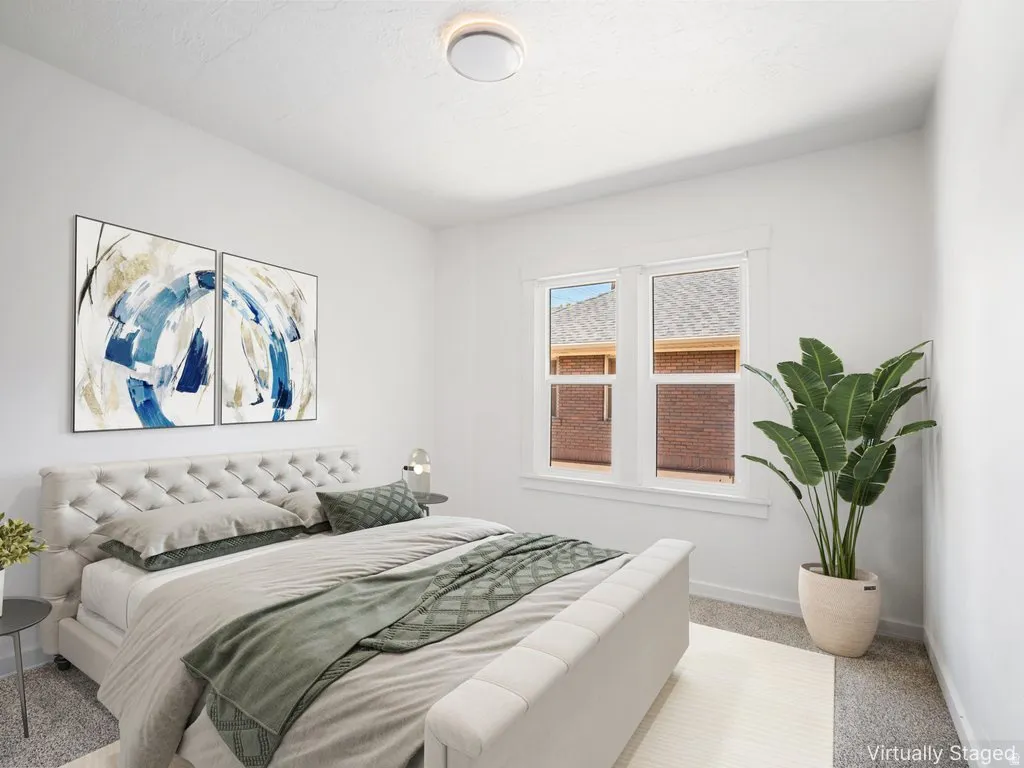 Bright room featuring white walls, carpet flooring, a flush-mount ceiling light, and a double window with white trim