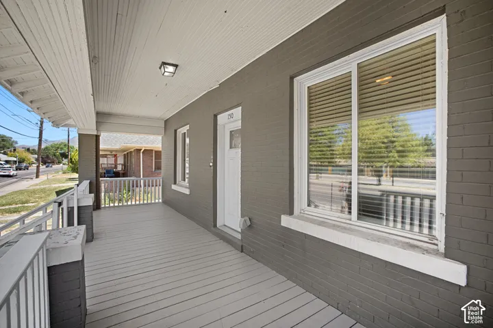 Inviting covered front porch with painted wood-finish flooring