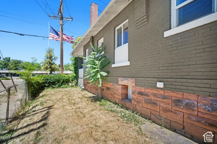 Exterior brick siding in a neutral tone and a decorative stone-look foundation