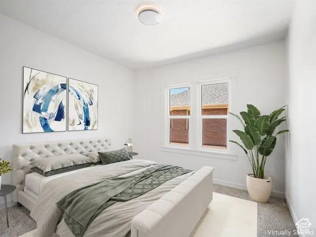 Bright room featuring white walls, carpet flooring, a flush-mount ceiling light, and a double window with white trim