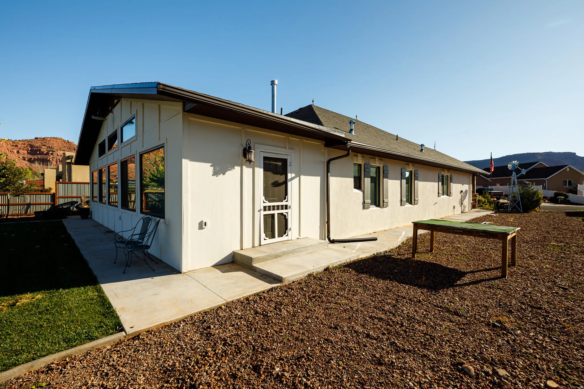Exterior of a property featuring stucco siding and a pitched shingle roof
