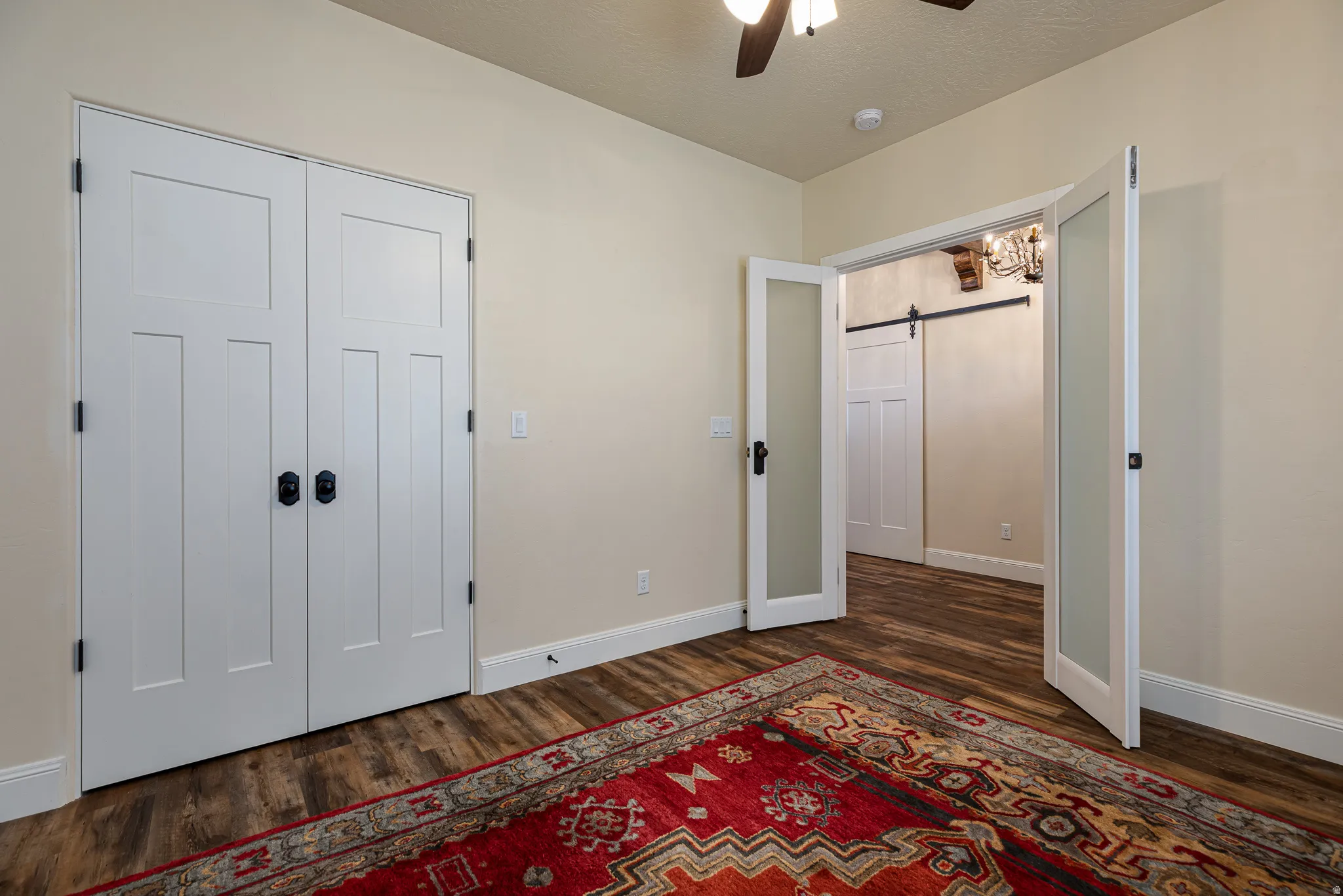 Interior room featuring wood-finish flooring, white baseboards, and neutral wall paint