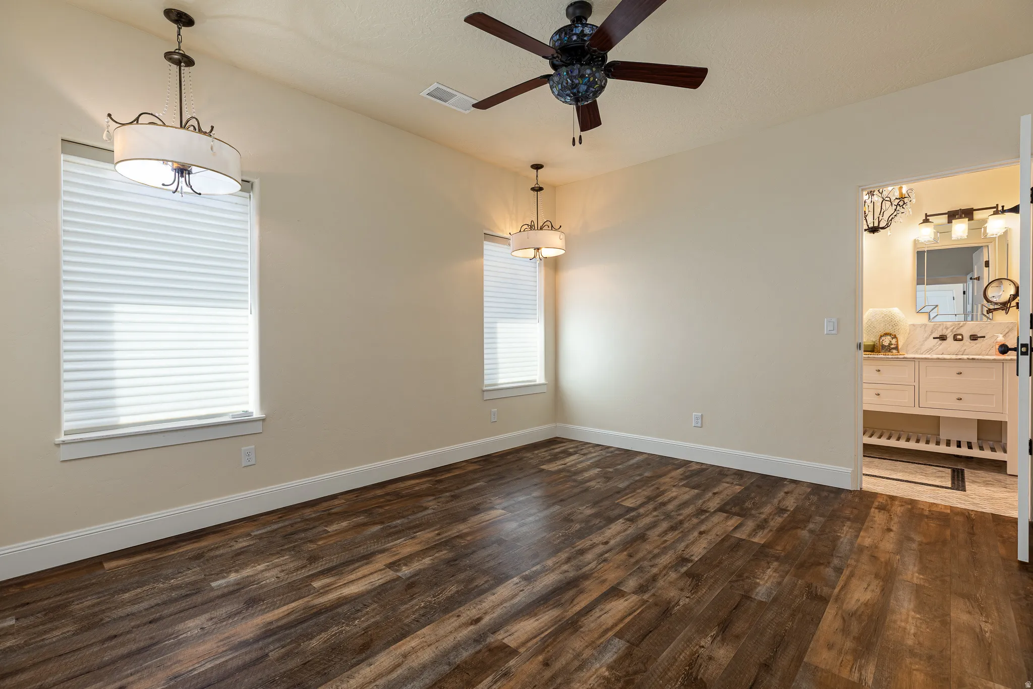 Spacious room featuring wood-finish flooring and neutral wall tones