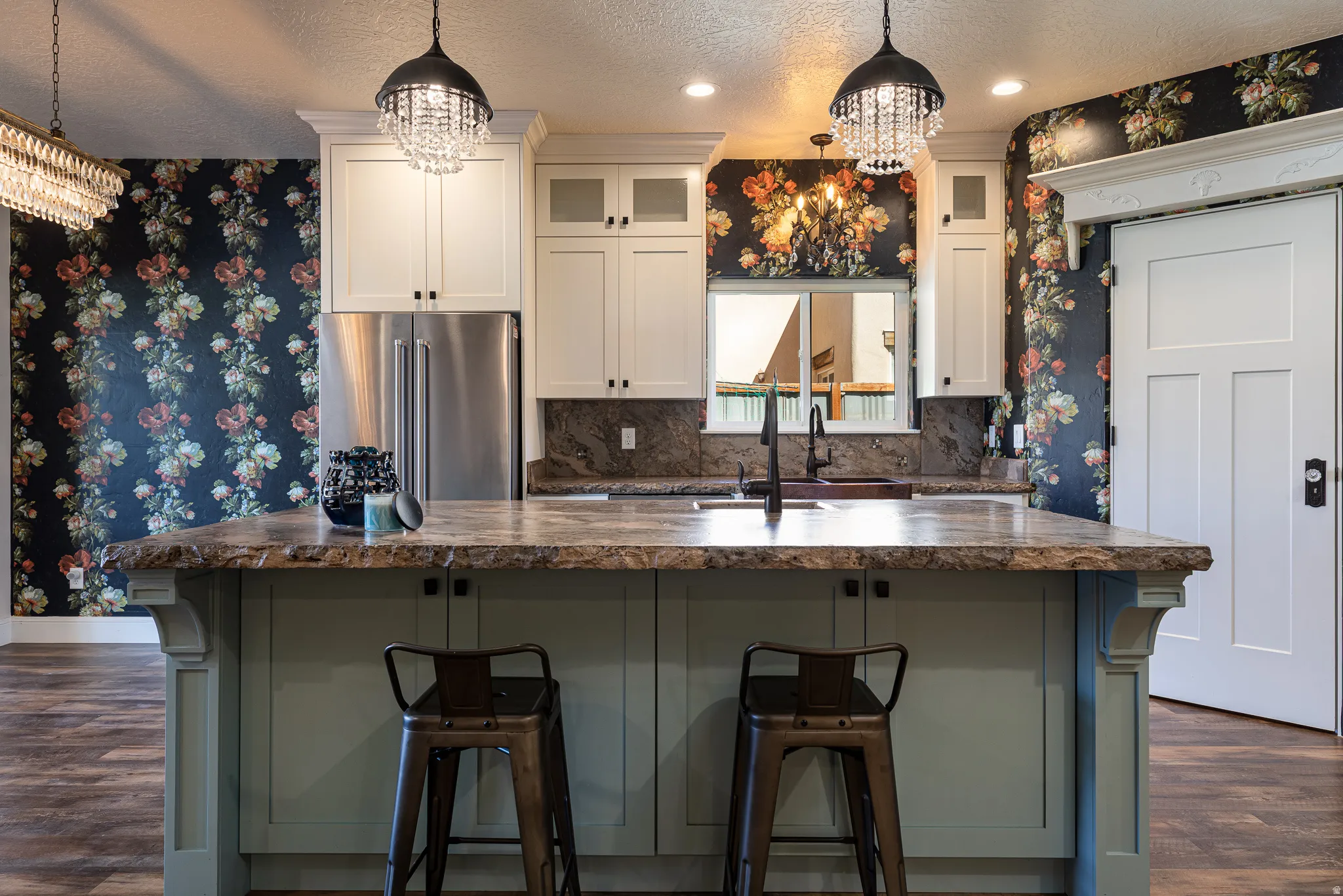 Kitchen island featuring a live-edge countertop and light green cabinetry