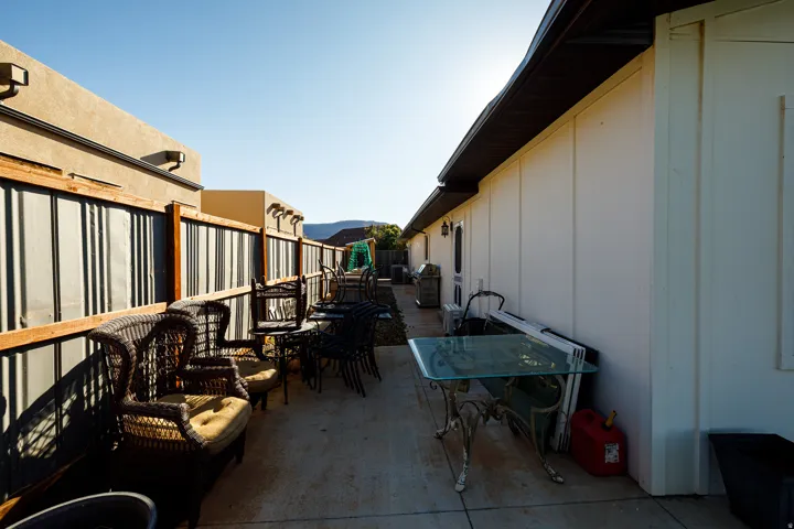 Concrete patio area featuring a stucco-finished exterior wall and a board-and-batten style exterior wall