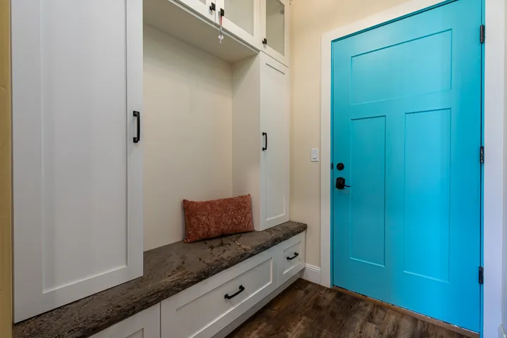 Entryway with wood-finish flooring and a bright blue door