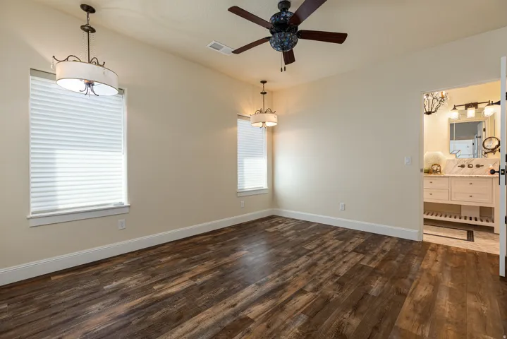 Spacious room featuring wood-finish flooring and neutral wall tones