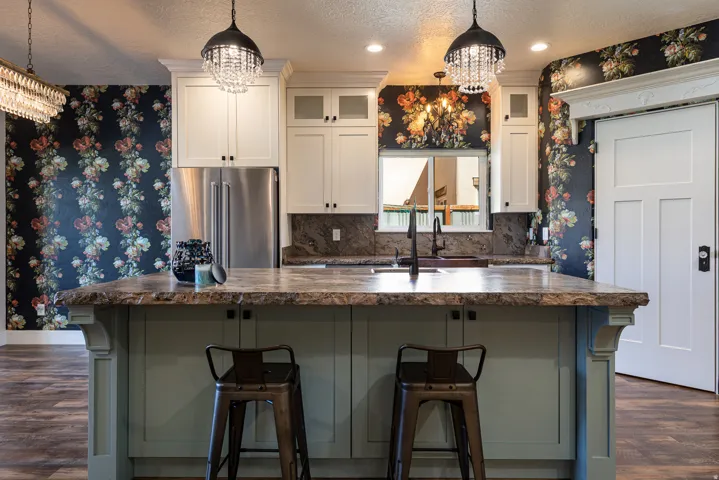 Kitchen island featuring a live-edge countertop and light green cabinetry