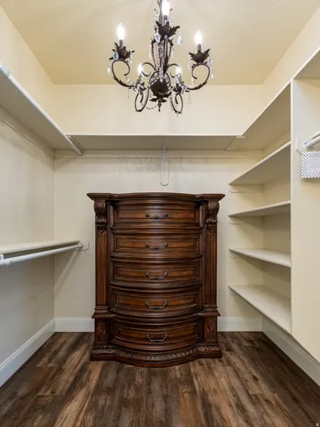 Wood-finish flooring throughout, complemented by a decorative chandelier