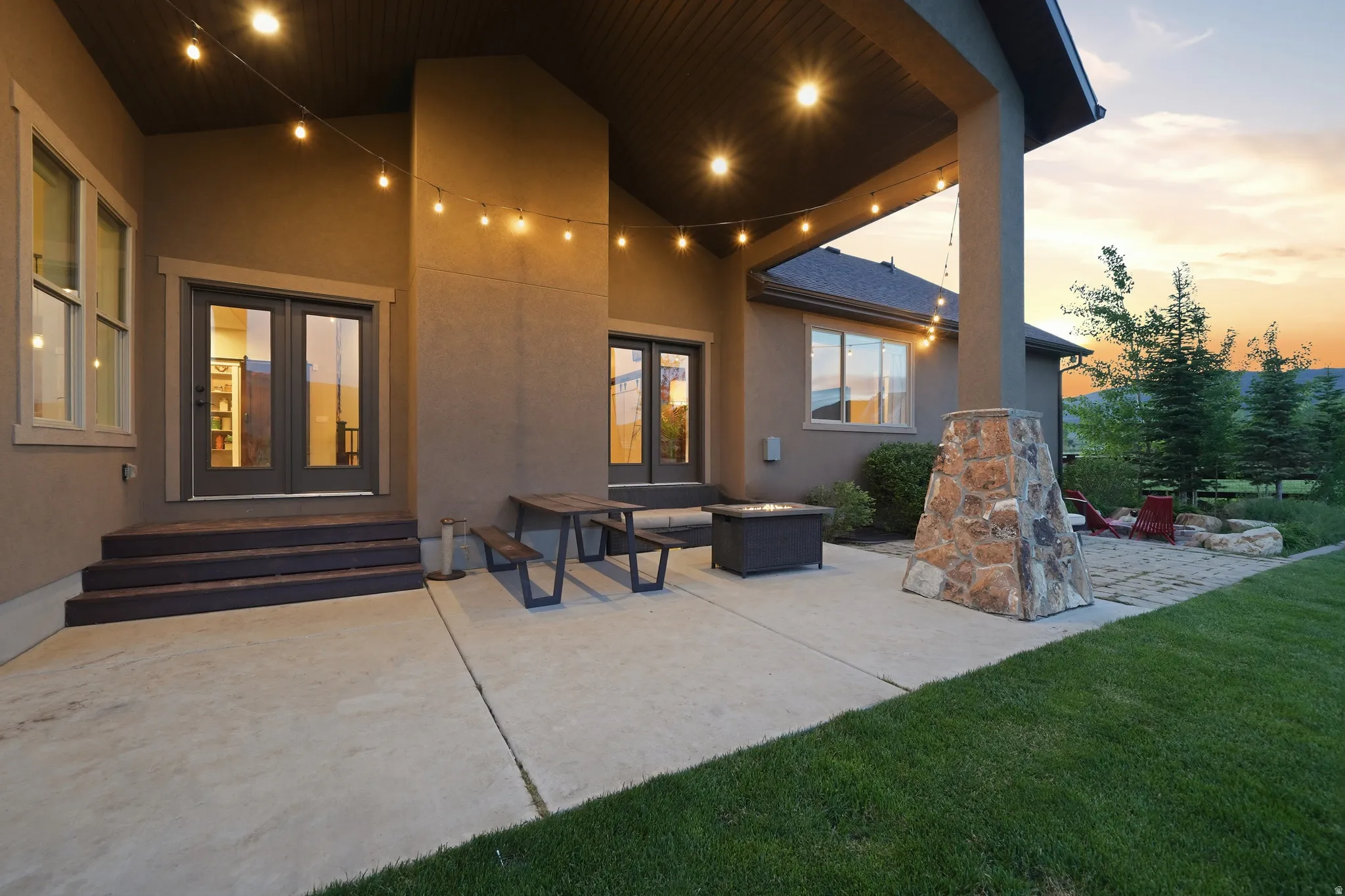 Expansive concrete patio area with a covered porch