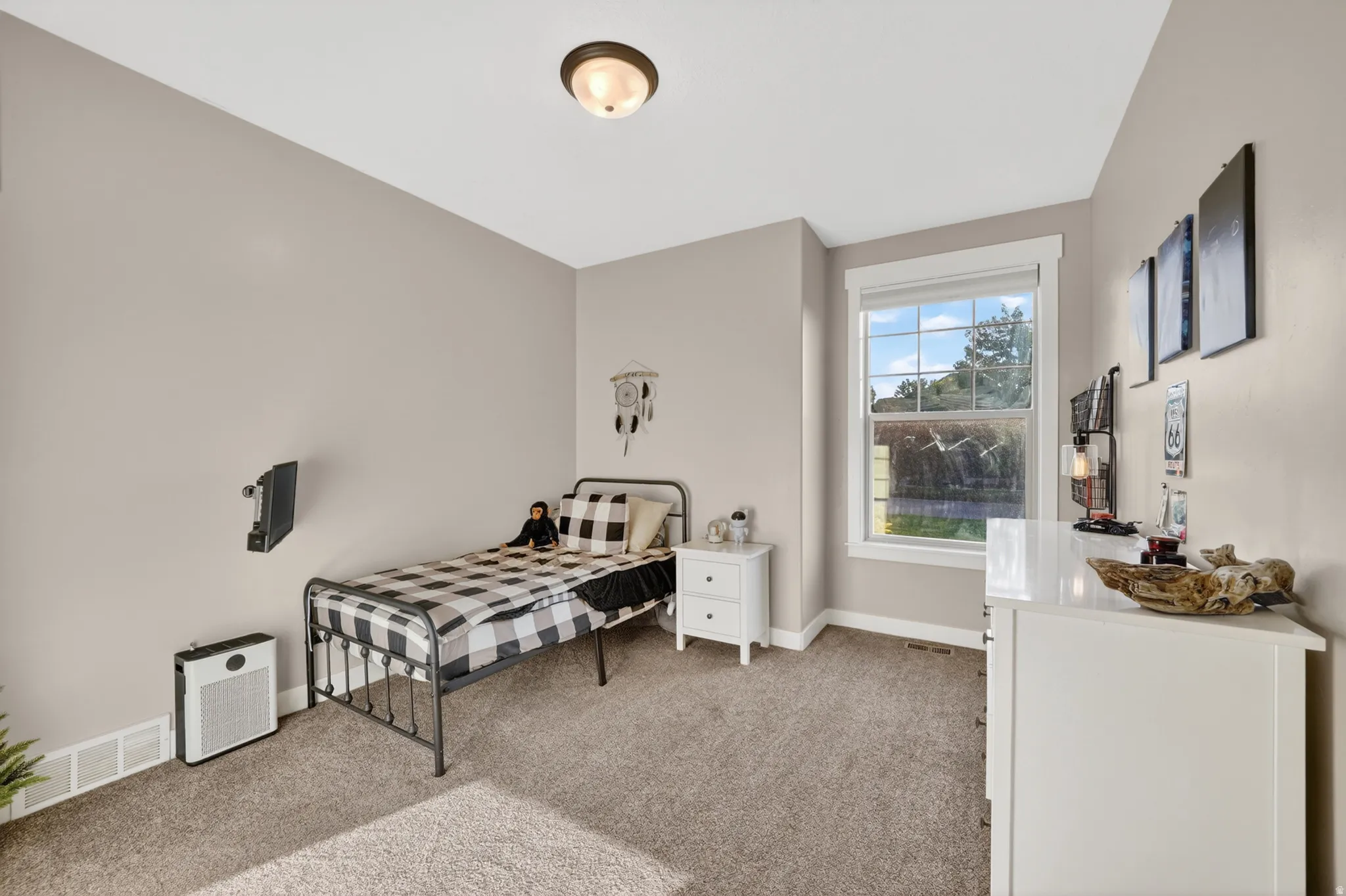 Carpeted room with a double-hung window, crown molding, and a flush mount ceiling light