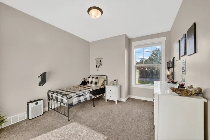 Carpeted room with a double-hung window, crown molding, and a flush mount ceiling light