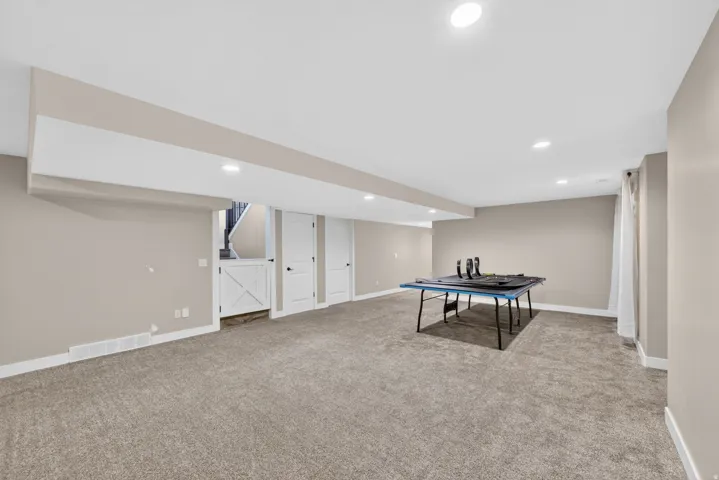 Expansive carpeted room featuring recessed lighting and neutral wall tones