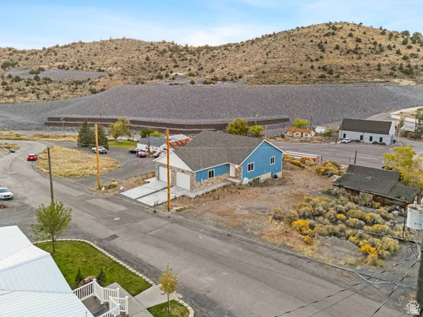 New construction home featuring a blue exterior with stone accents and a two-car attached garage
