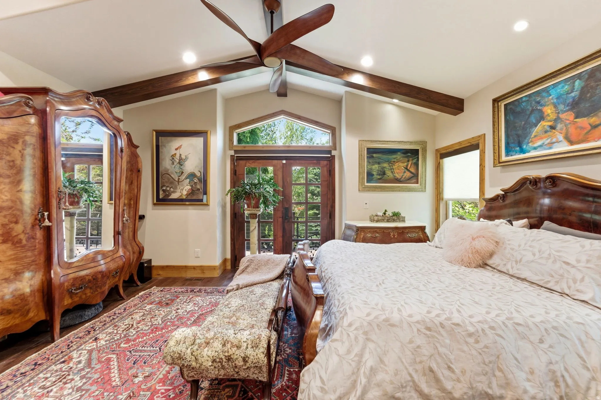 Vaulted ceiling featuring exposed wood beams and recessed lighting