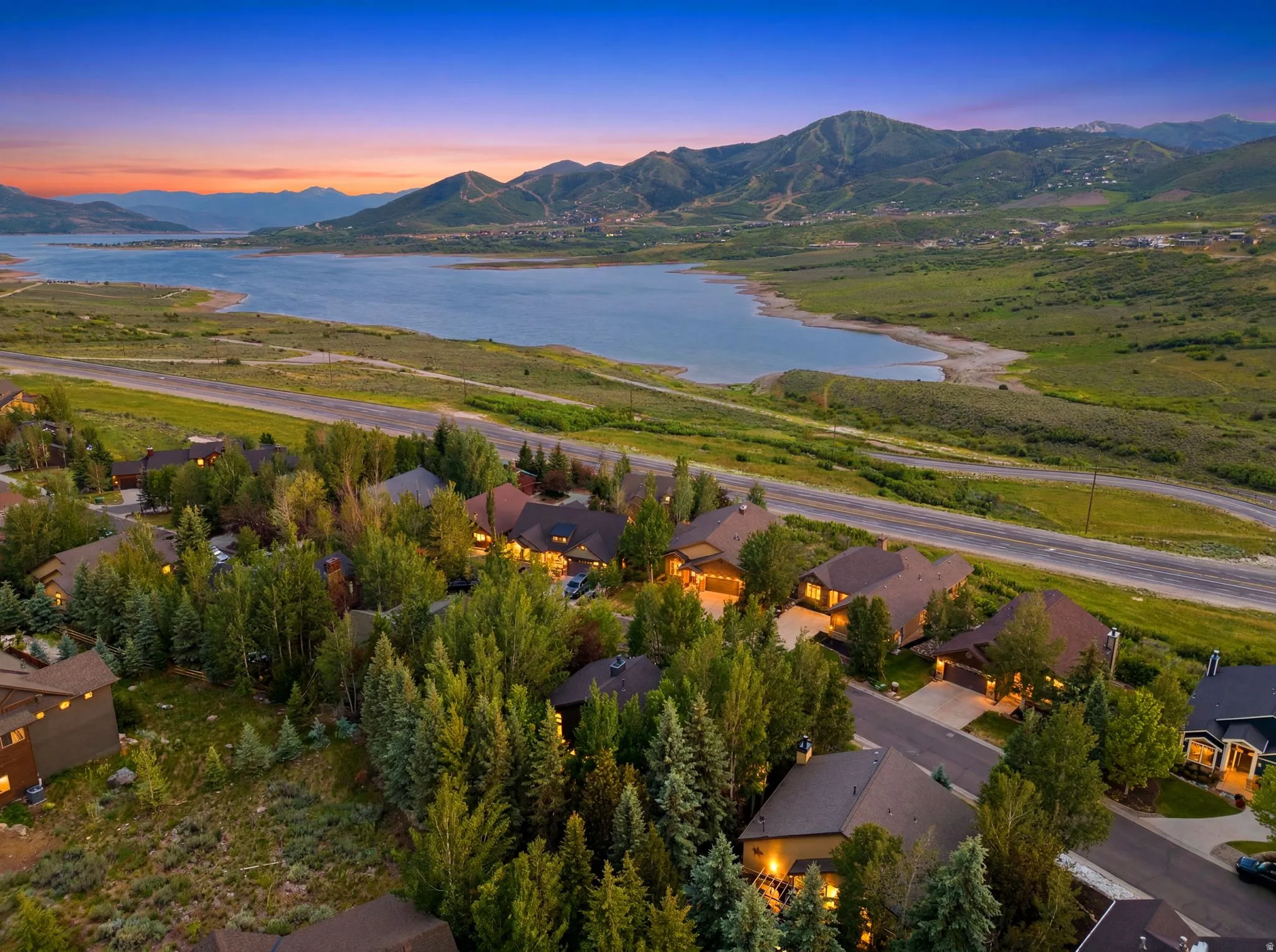 Expansive neighborhood featuring mature trees, paved streets, and residential properties