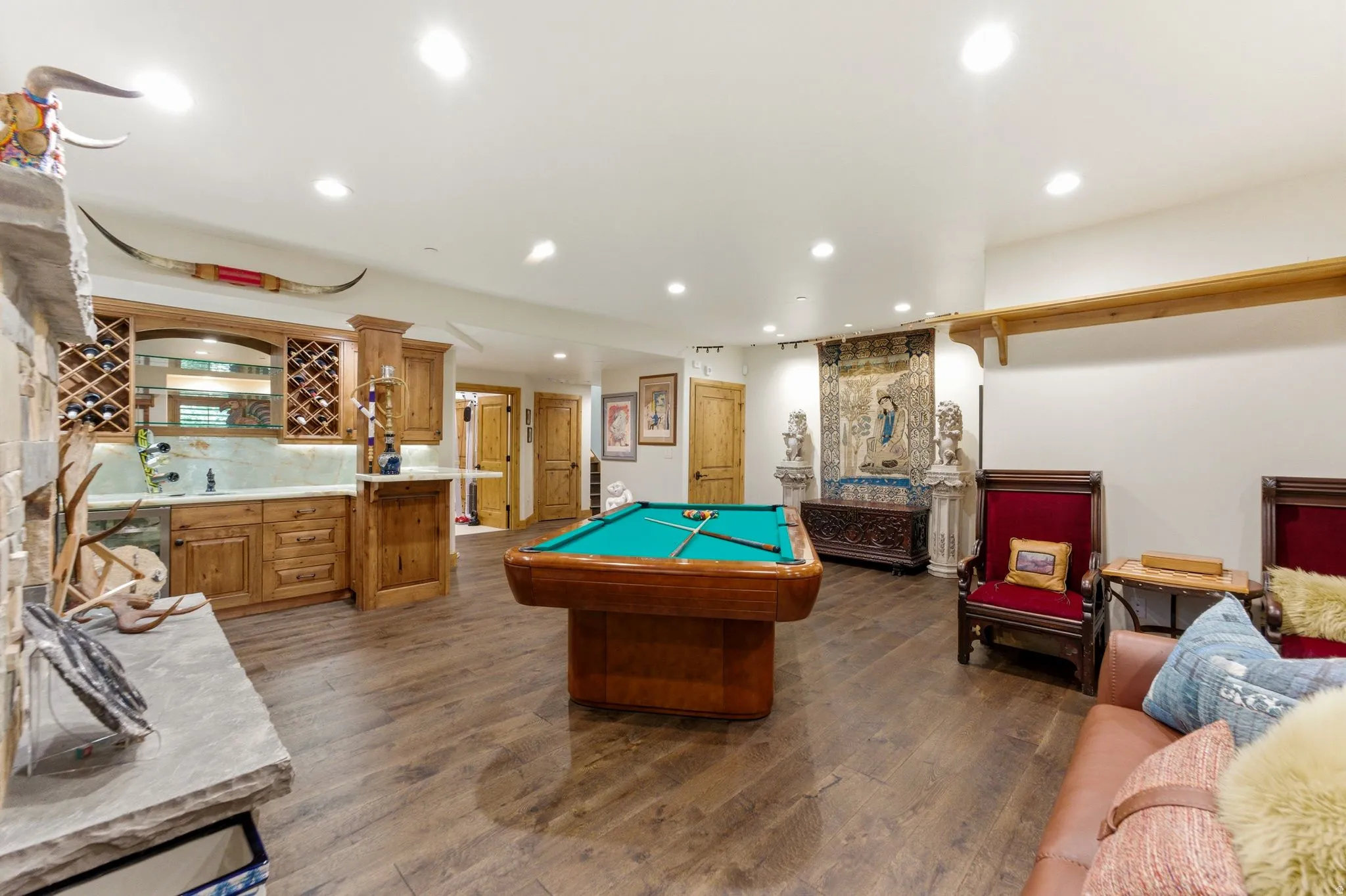 Entertainment space featuring a built-in wet bar with wood cabinetry and wine storage