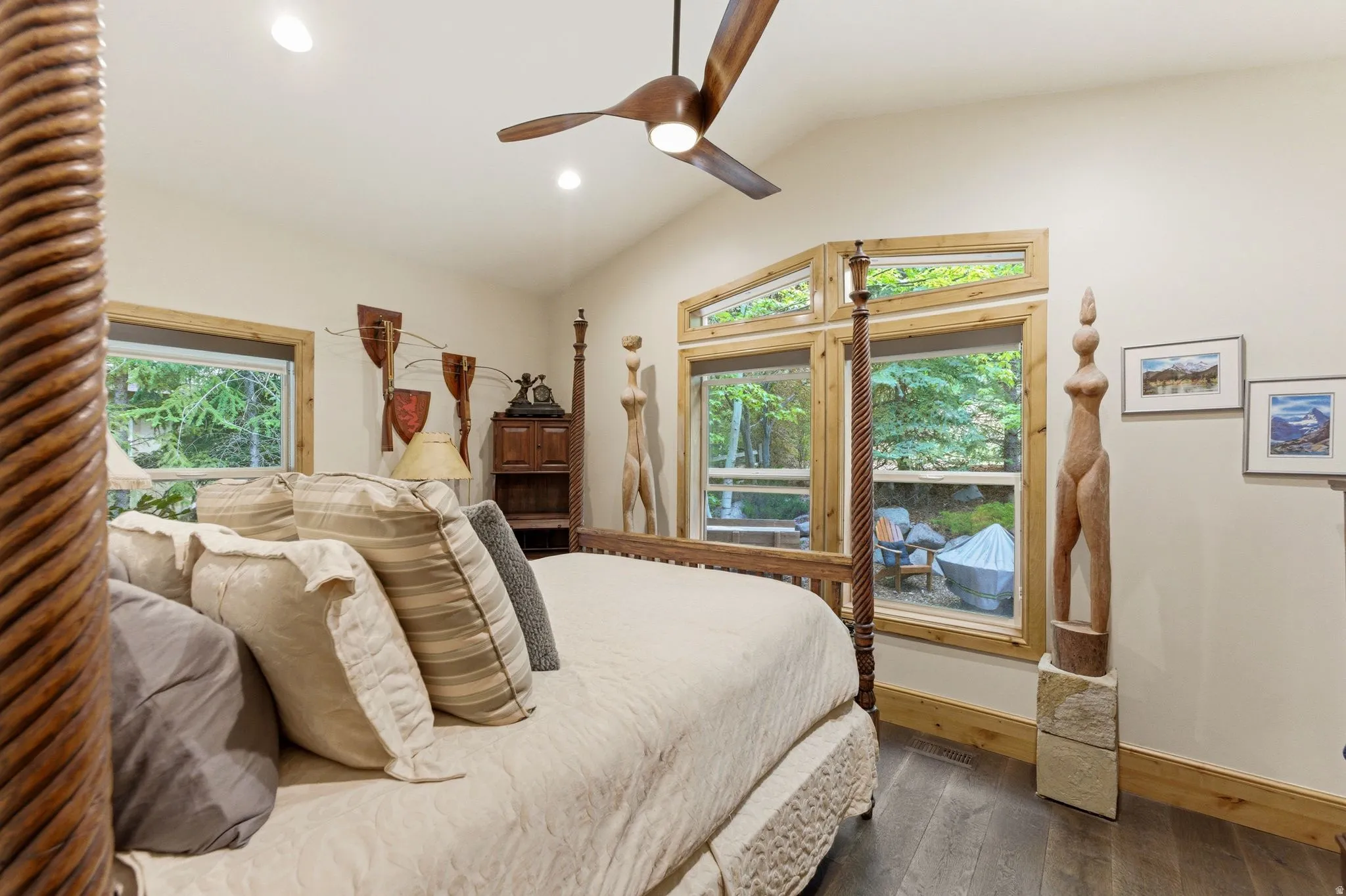 Vaulted ceiling with recessed lighting and a wood-bladed ceiling fan