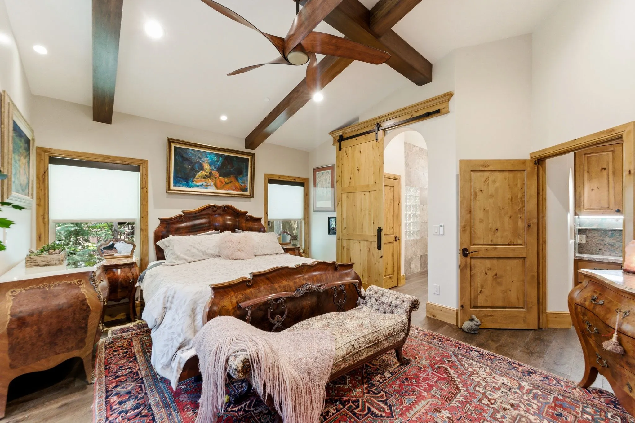 Vaulted ceiling with exposed wood beams and recessed lighting