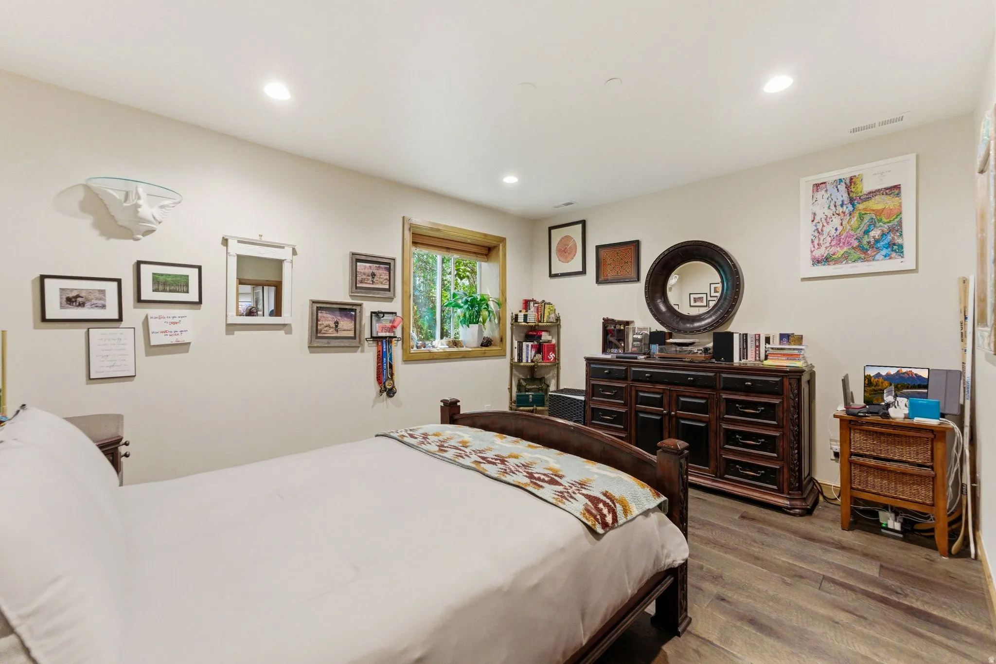Room featuring wood-finish flooring, recessed lighting, and light-toned walls