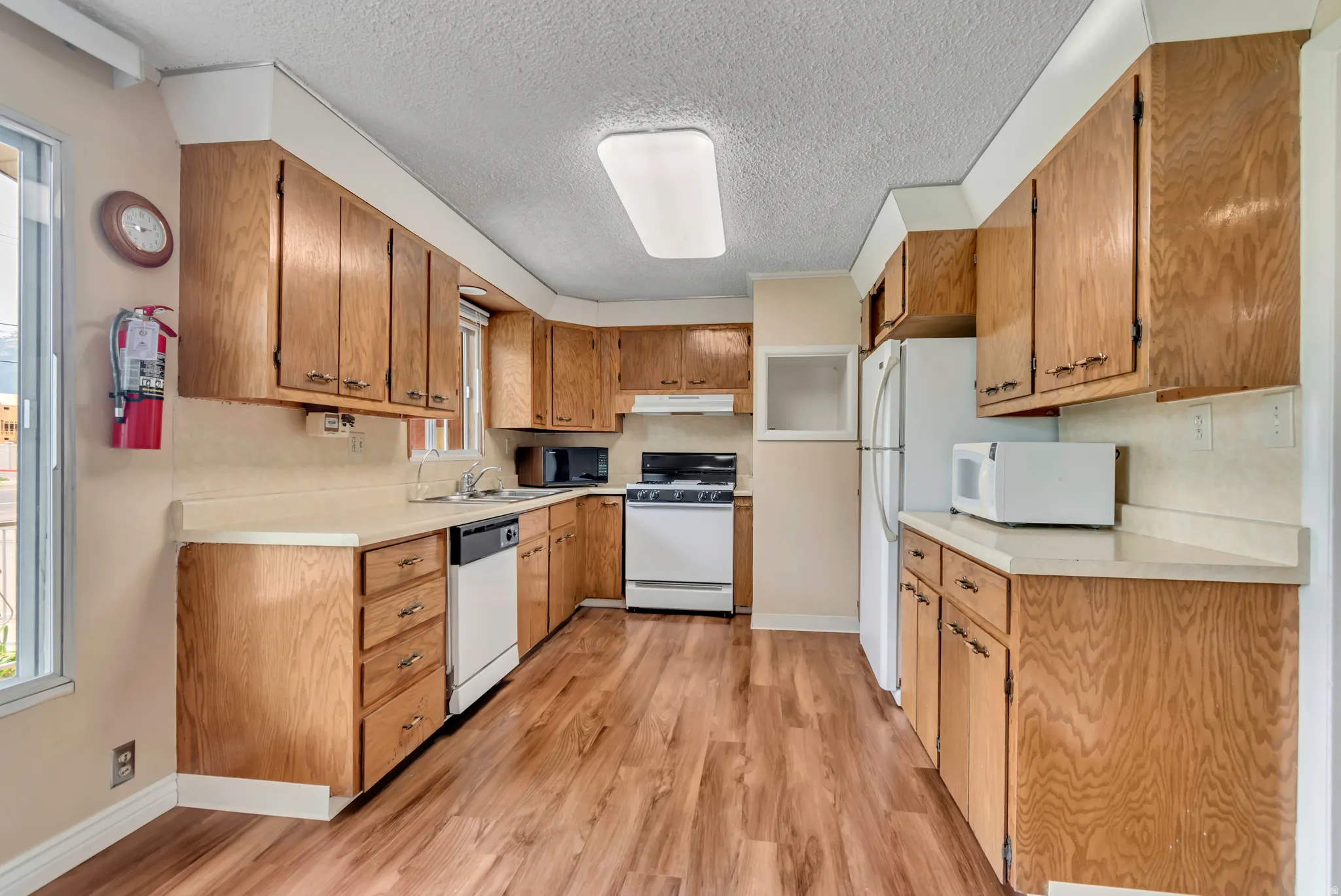 Kitchen featuring wood-finish flooring, and abundant wood cabinetry