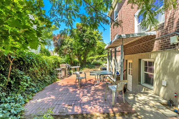 Unit 3 Brick patio area featuring a metal awning and an exterior door