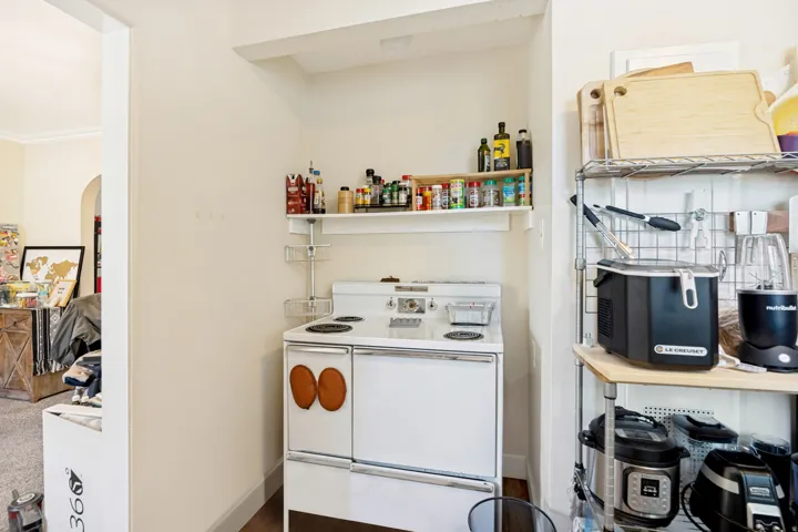 Unit 1 Kitchen alcove featuring a white stand-alone range with four burners and a lower oven