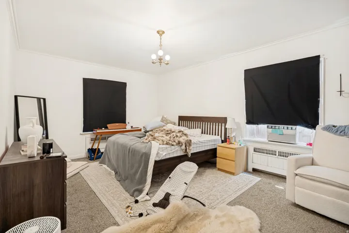 Unit 2 Spacious interior featuring crown molding, neutral wall tones, and recessed window openings
