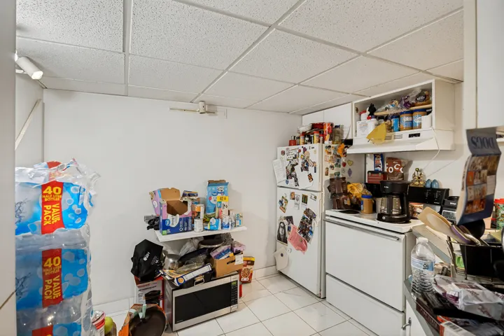Unit 3 White tile flooring and a drop ceiling with recessed lighting