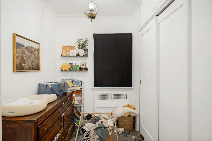 Unit 2 White painted walls with crown molding and a ceiling-mounted fixture