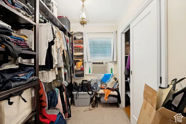 Unit 1 Custom closet system featuring dark wood-finish shelving and hanging rods