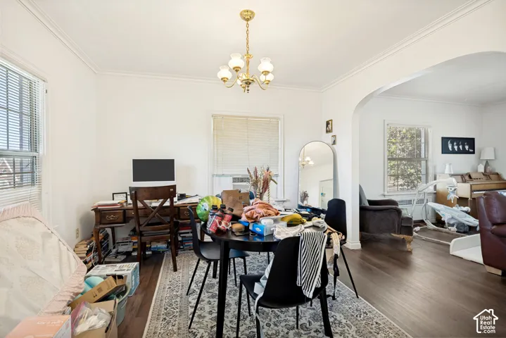 Unit 2  Bright interior space featuring wood-finish flooring, white walls, and a decorative archway