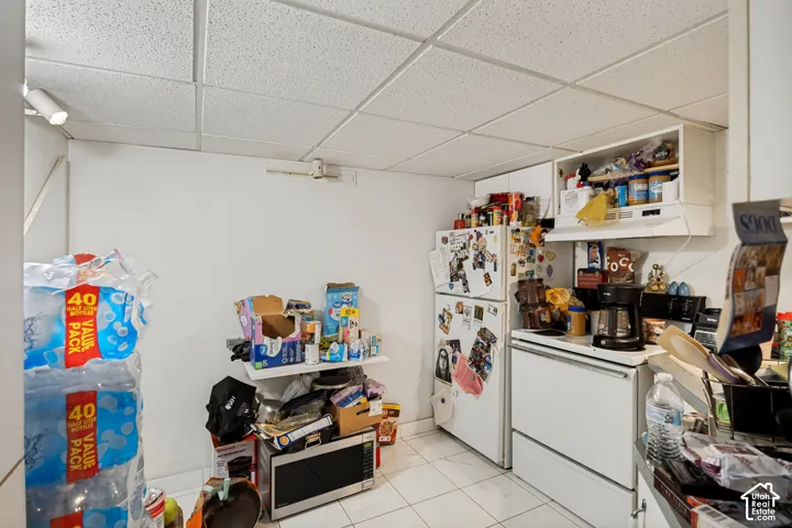Unit 3 White tile flooring and a drop ceiling with recessed lighting