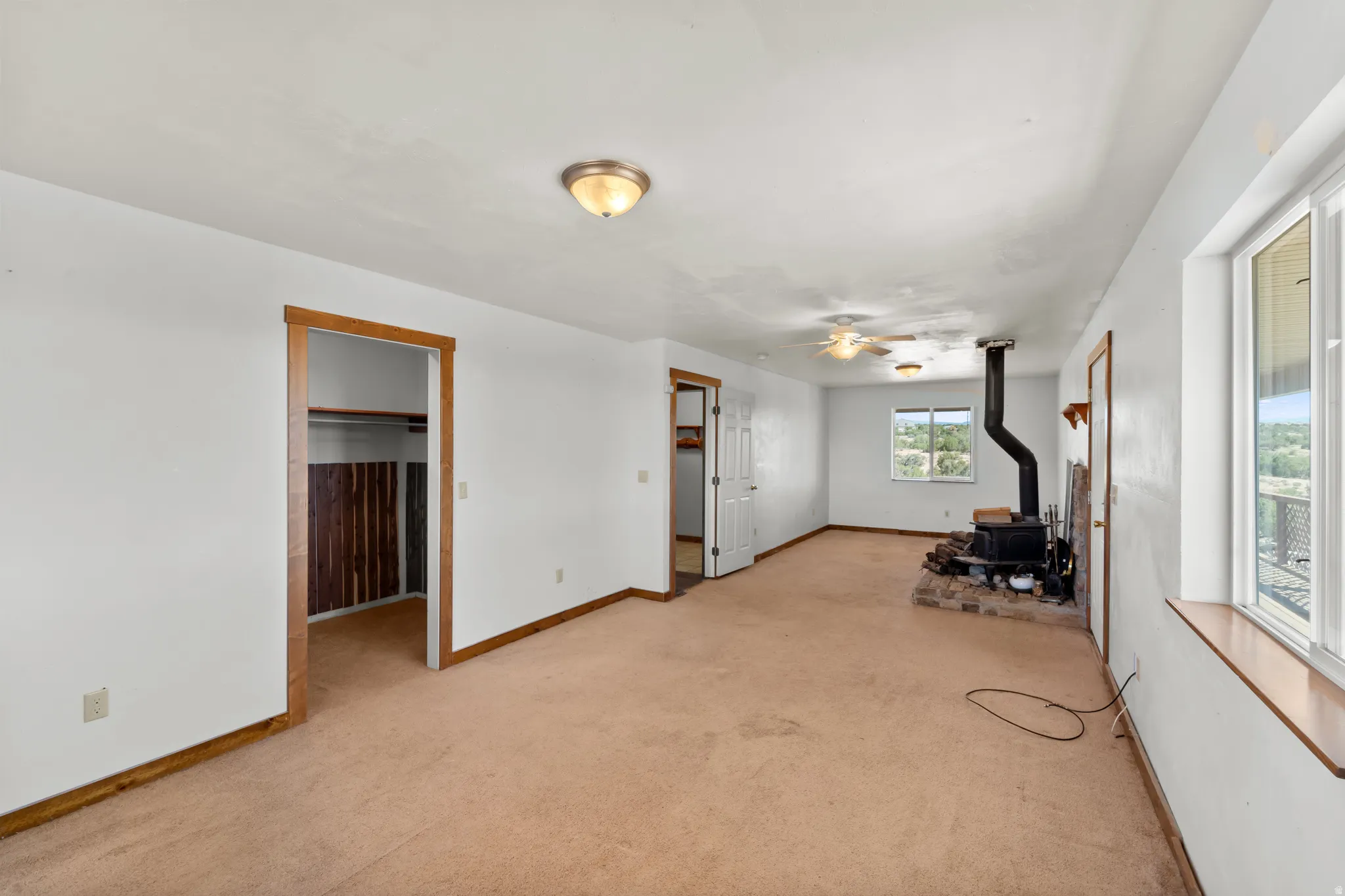 The Primary bedroom has a door to the huge wrap around porch and a cozzy wood stove. The other half of the room was designed as a "craft room" but could easily be another bedroom. The bedroom also has a huge walk in cosset.