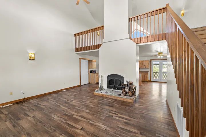 Looking from the front door through to the kitchen and garage door to the top left and the dinning room in the top right and the loft above.