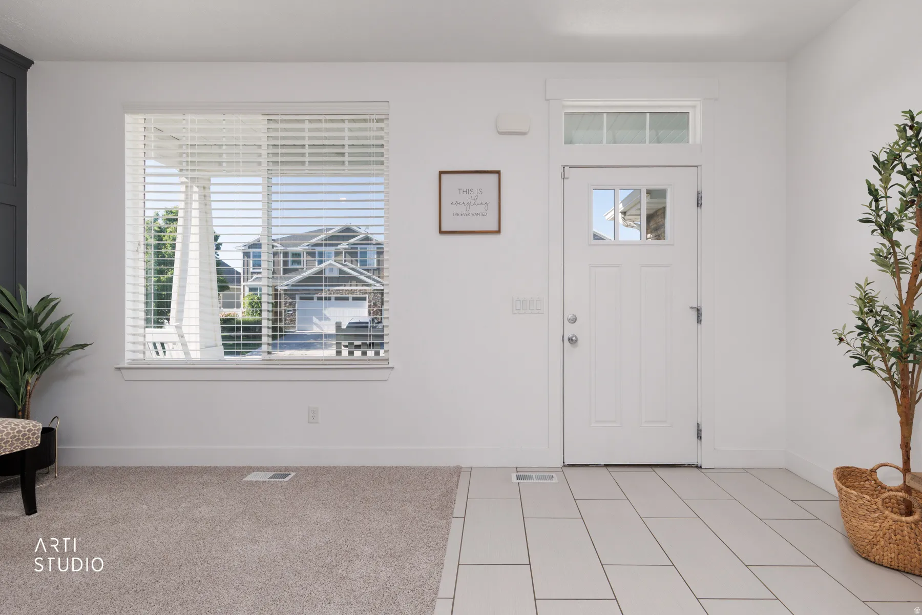 Entryway featuring a white door with upper window panes and a transom window
