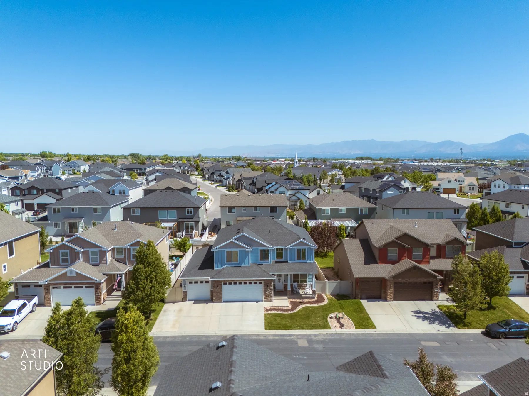 Expansive residential neighborhood featuring a variety of architectural styles, mature landscaping, and mountain scenery