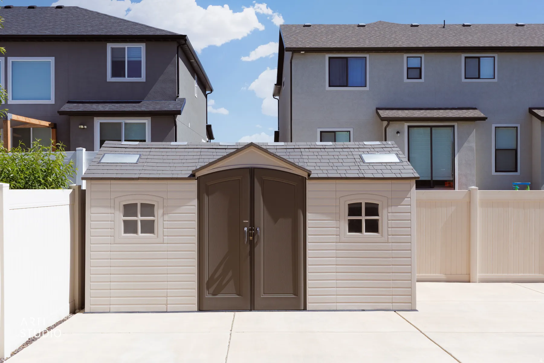 Detached storage shed featuring double doors, two skylights, and two side windows