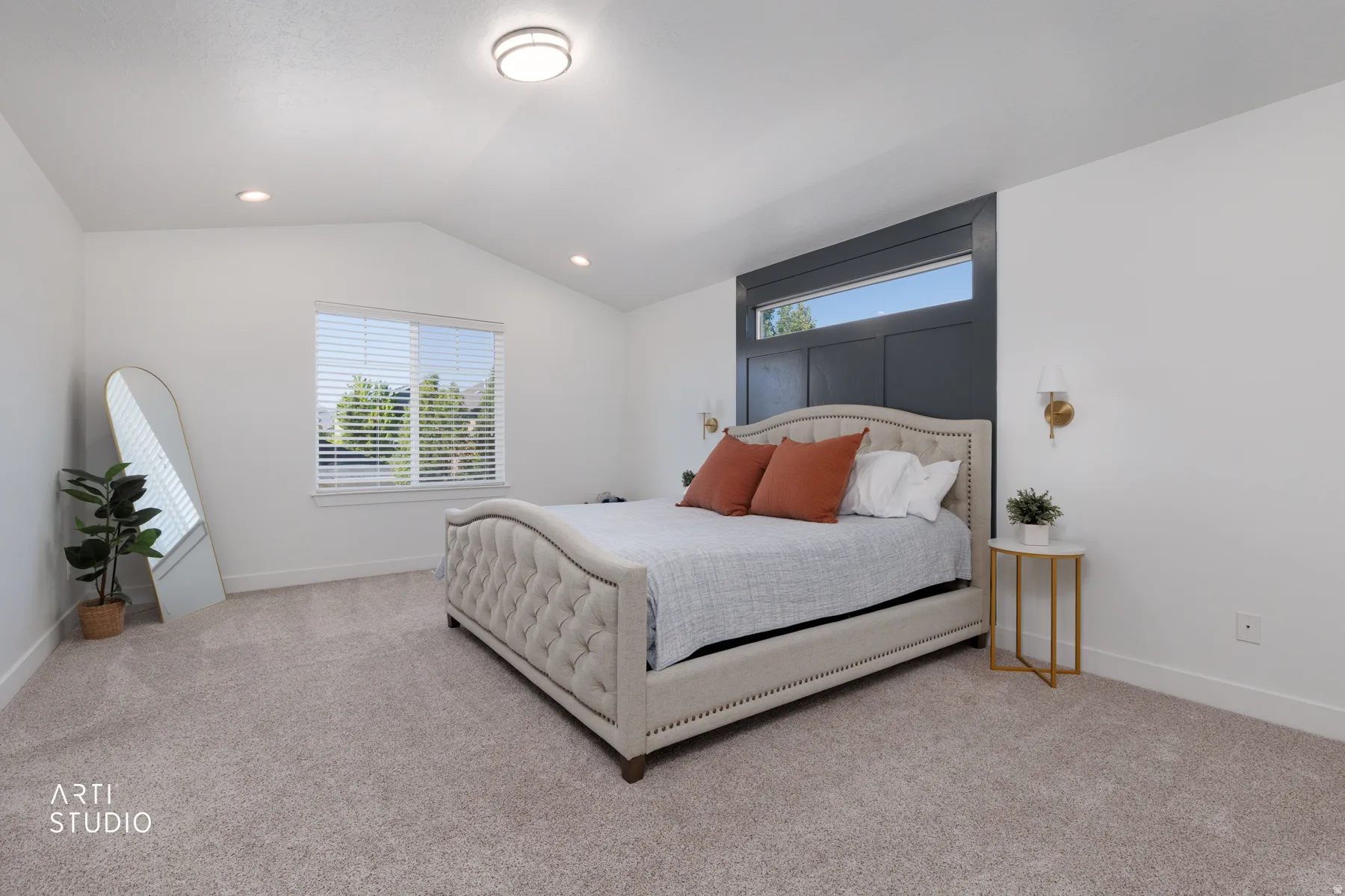 Spacious room featuring vaulted ceilings, recessed lighting, and a large window with blinds